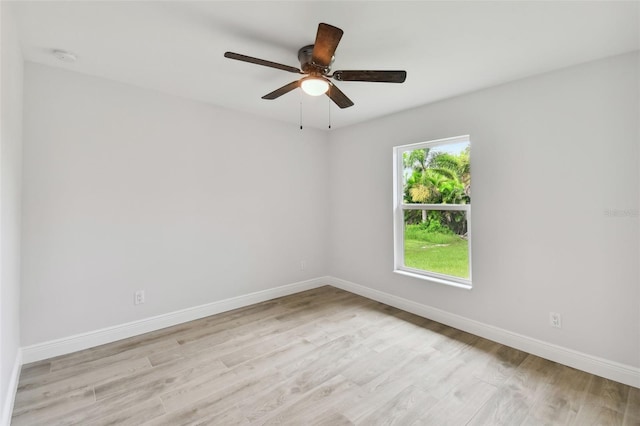 empty room with ceiling fan and light hardwood / wood-style flooring