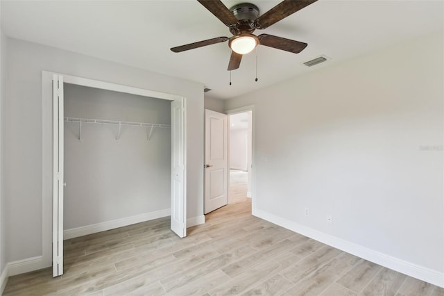 unfurnished bedroom featuring ceiling fan, a closet, and light hardwood / wood-style floors