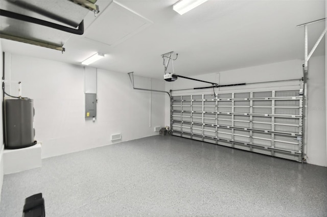 18854 Ackerman Ave, Port Charlotte, FL 33948 - garage with water heater, a garage door opener, and electric panel