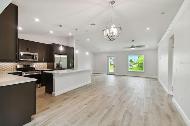 18854 Ackerman Ave, Port Charlotte, FL 33948 - kitchen featuring appliances with stainless steel finishes, ceiling fan, a chandelier, light countertops, and open floor plan