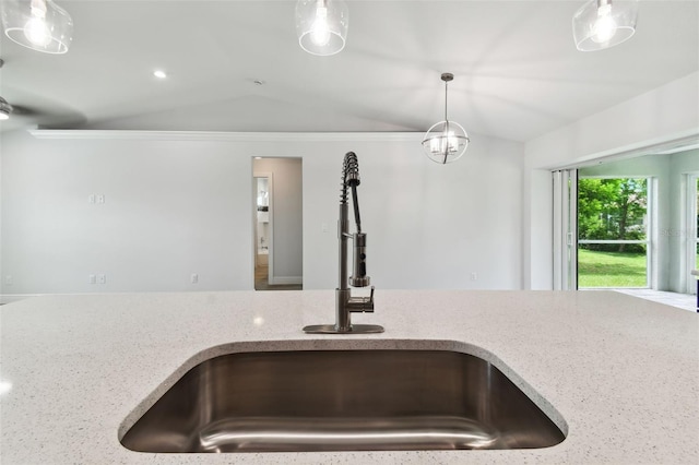 room details with light stone countertops, sink, and pendant lighting