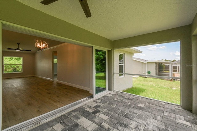 18854 Ackerman Ave, Port Charlotte, FL 33948 - unfurnished sunroom featuring a ceiling fan and a chandelier