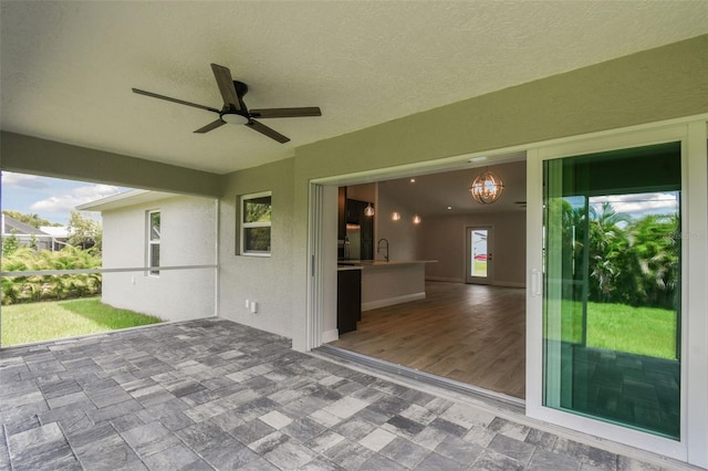 view of patio / terrace with ceiling fan and sink