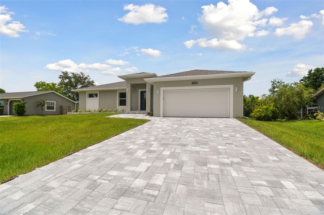 18854 Ackerman Ave, Port Charlotte, FL 33948 - view of front facade featuring decorative driveway, a front lawn, an attached garage, and stucco siding