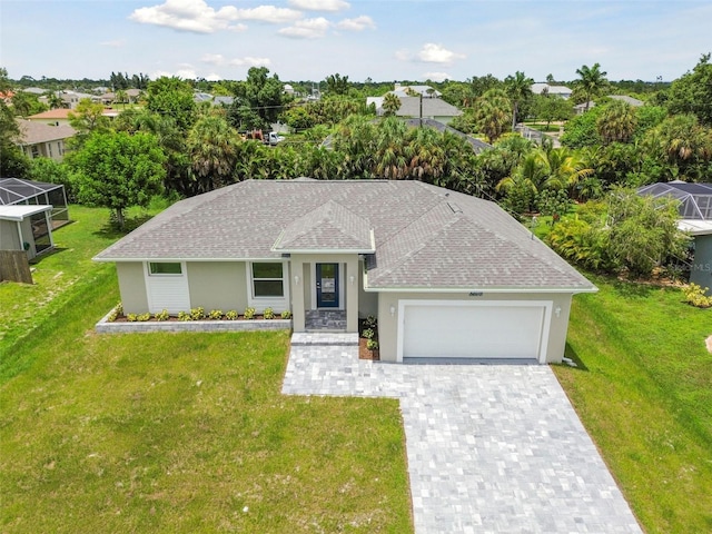 single story home with a garage and a front lawn