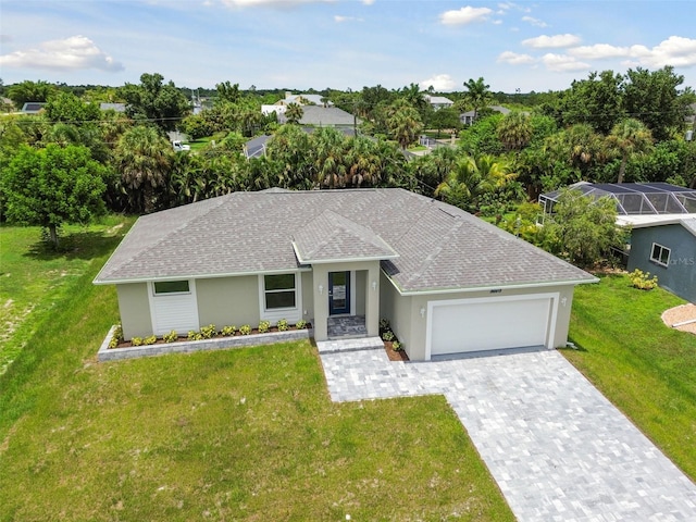 single story home featuring a front lawn and a garage