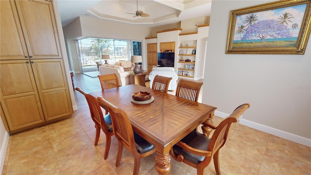 tiled dining space featuring ceiling fan and built in features