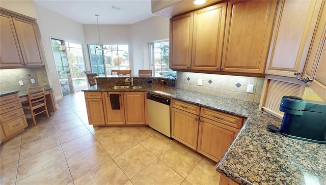 kitchen with kitchen peninsula, pendant lighting, a notable chandelier, dishwasher, and plenty of natural light