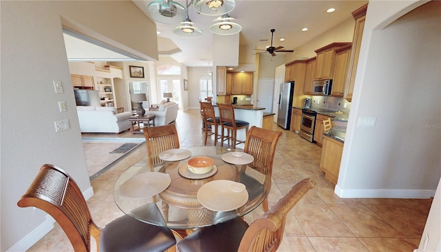 dining space featuring ceiling fan and light tile patterned flooring