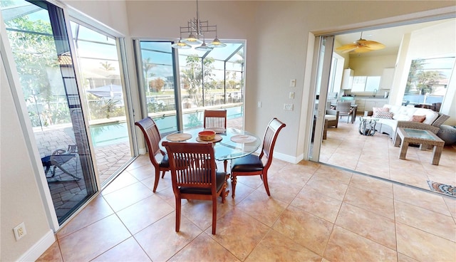 dining area featuring ceiling fan, light tile patterned flooring, and a wealth of natural light