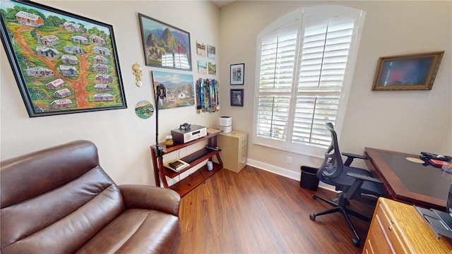 office with dark hardwood / wood-style flooring and a wealth of natural light