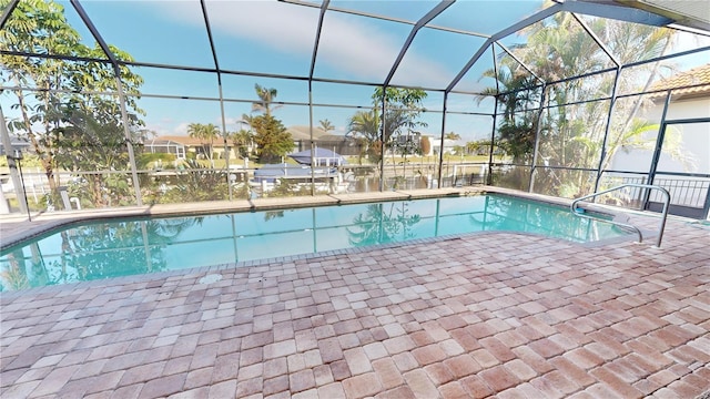 view of swimming pool with a lanai and a patio area