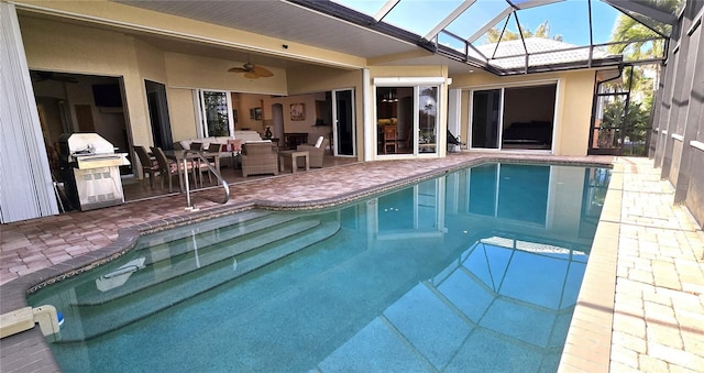 view of pool with ceiling fan, a lanai, an outdoor living space, and a patio