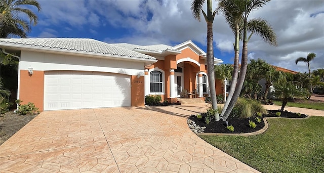 mediterranean / spanish house with a garage