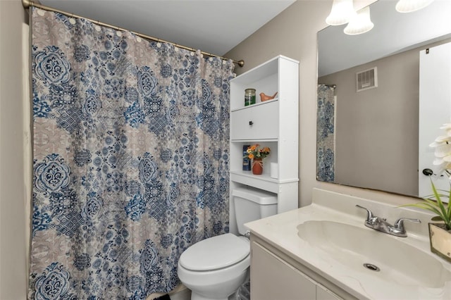 bathroom with vanity, curtained shower, and toilet