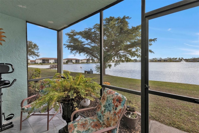 sunroom / solarium featuring a water view