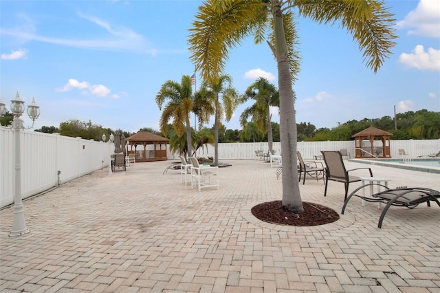 view of patio featuring a gazebo and a community pool