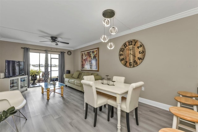 dining area with ornamental molding, hardwood / wood-style floors, and ceiling fan