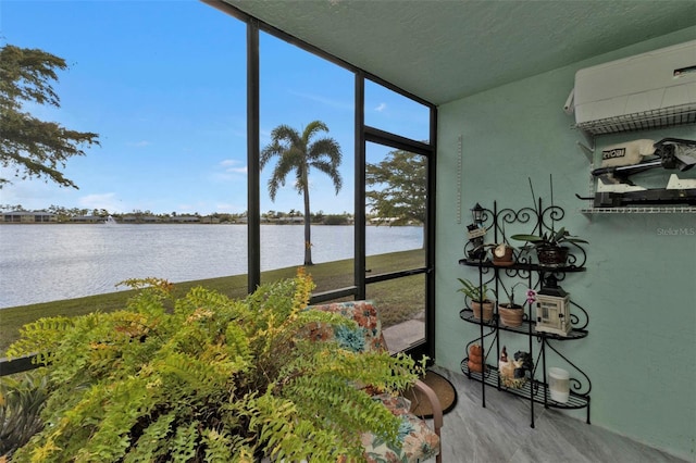 sunroom featuring a water view