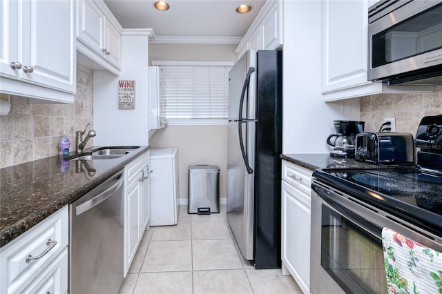 kitchen with appliances with stainless steel finishes, backsplash, crown molding, sink, and white cabinets