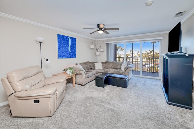 living room featuring ceiling fan, light carpet, and ornamental molding