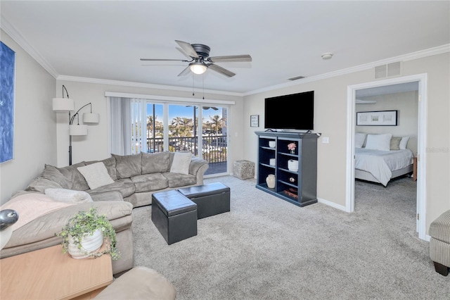 living room with carpet flooring, crown molding, and ceiling fan