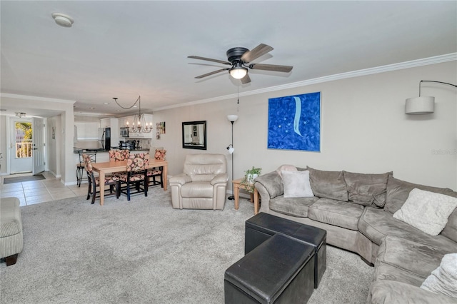 carpeted living room with ceiling fan with notable chandelier and ornamental molding