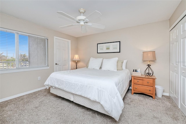 carpeted bedroom featuring ceiling fan and a closet