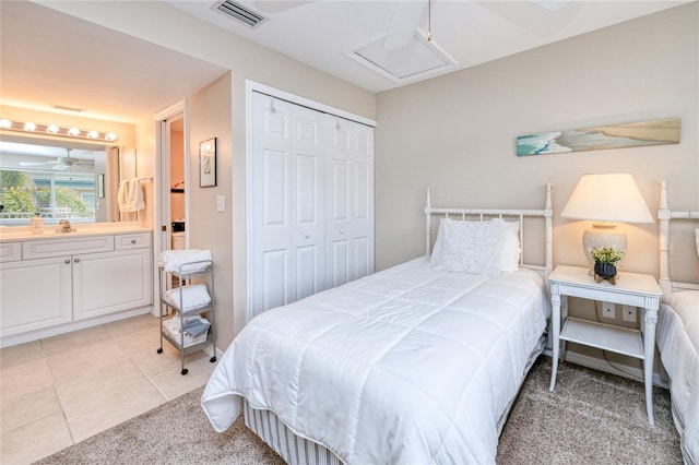 bedroom with light carpet, a closet, and sink