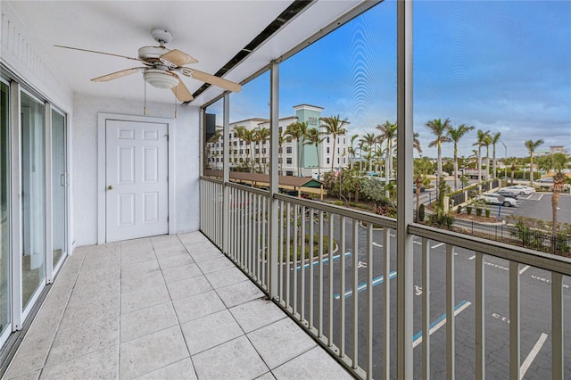 unfurnished sunroom featuring ceiling fan