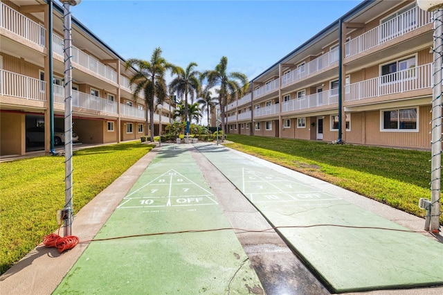 view of home's community with a yard