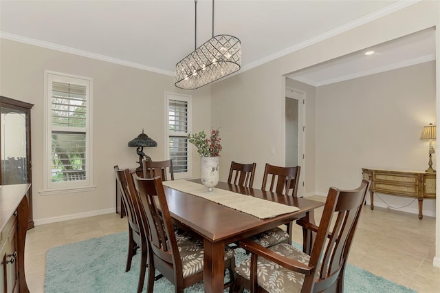 tiled dining area featuring ornamental molding and an inviting chandelier