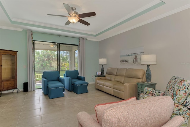 tiled living room featuring ceiling fan, crown molding, and a tray ceiling