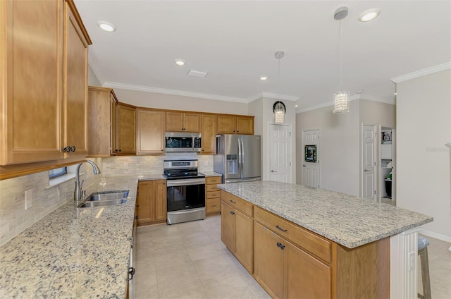 kitchen featuring light stone counters, stainless steel appliances, sink, a center island, and hanging light fixtures