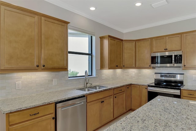 kitchen with sink, light stone countertops, ornamental molding, appliances with stainless steel finishes, and tasteful backsplash