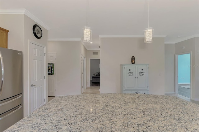 kitchen with stainless steel fridge, crown molding, hanging light fixtures, and a notable chandelier