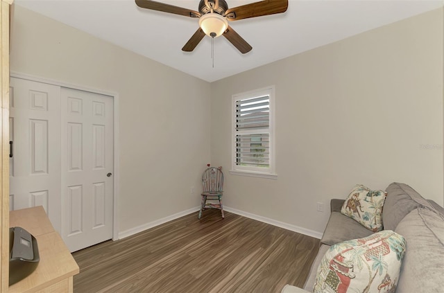 sitting room with dark hardwood / wood-style flooring and ceiling fan