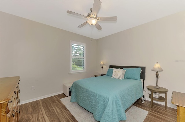 bedroom with hardwood / wood-style floors and ceiling fan