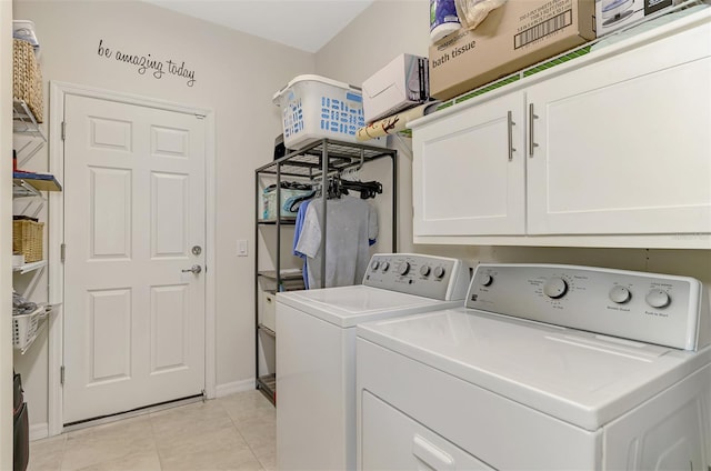 laundry area featuring light tile patterned floors, cabinets, and independent washer and dryer