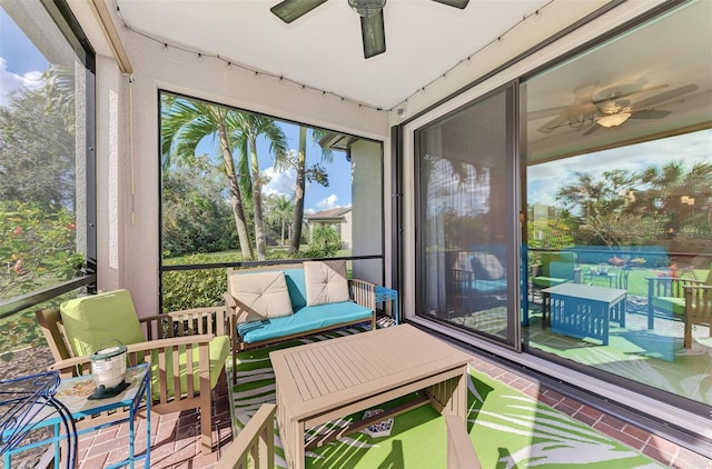 sunroom / solarium featuring ceiling fan