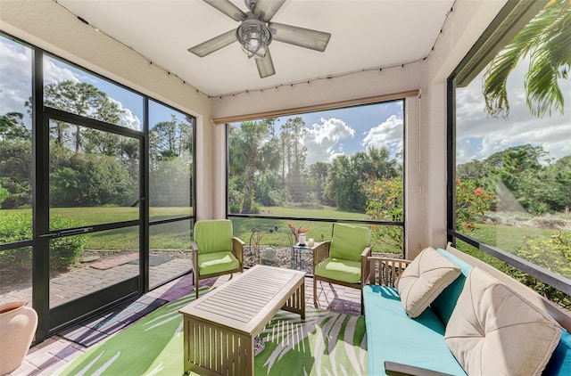 sunroom featuring ceiling fan