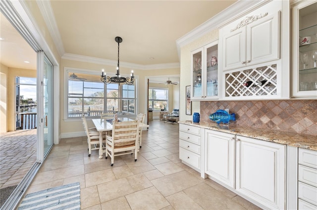 dining room with a notable chandelier and crown molding