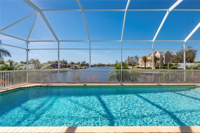 view of pool featuring glass enclosure