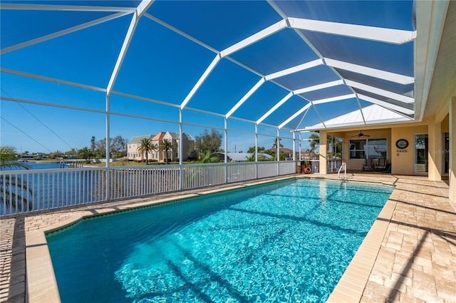 view of swimming pool featuring a patio, a lanai, and ceiling fan