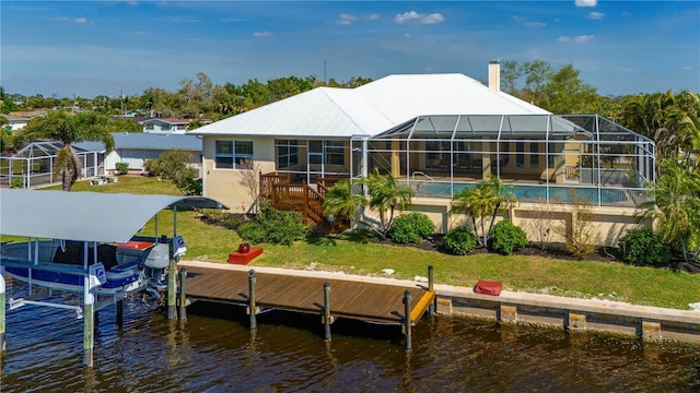 back of house featuring a yard, a lanai, and a water view