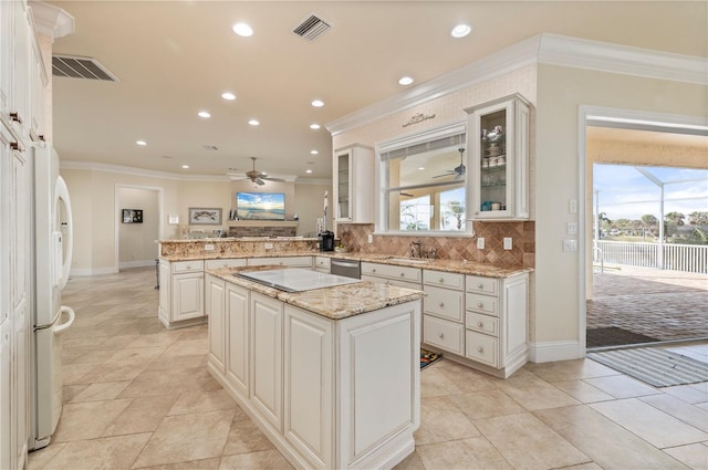 4431 Gardner Dr, Port Charlotte, FL 33952 - kitchen featuring ceiling fan, ornamental molding, a peninsula, freestanding refrigerator, and stainless steel dishwasher
