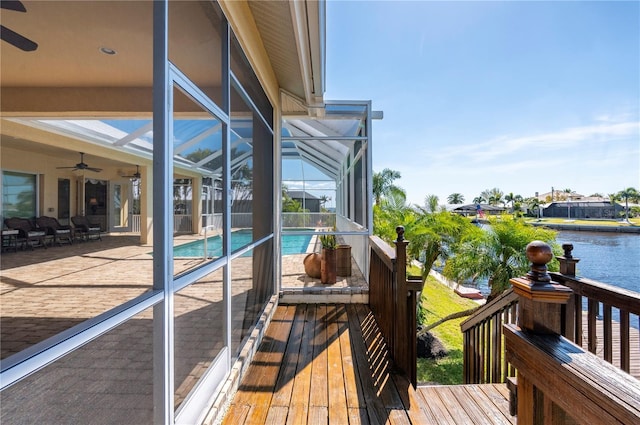 4431 Gardner Dr, Port Charlotte, FL 33952 - wooden deck with a ceiling fan, an outdoor pool, a water view, a patio, and a lanai