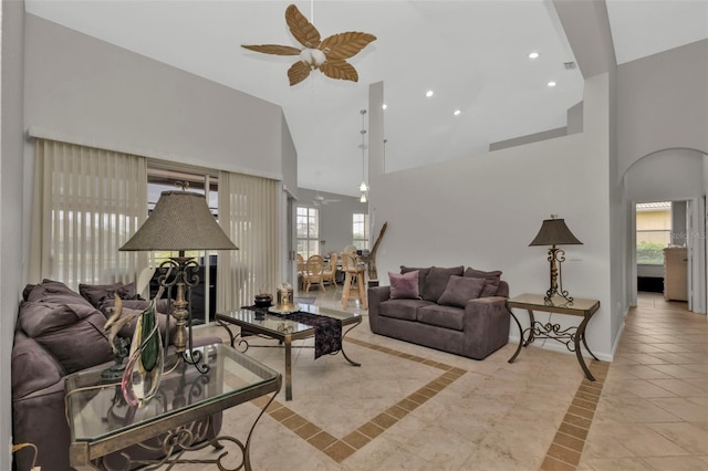 tiled living room with high vaulted ceiling and ceiling fan