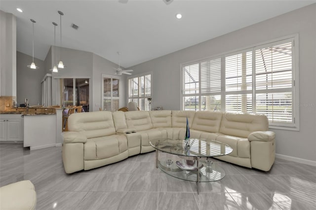 living room with light tile patterned floors, vaulted ceiling, and ceiling fan