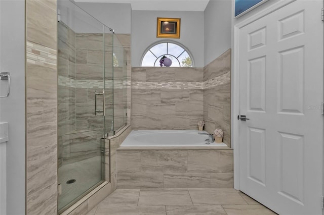 bathroom featuring shower with separate bathtub and tile patterned floors